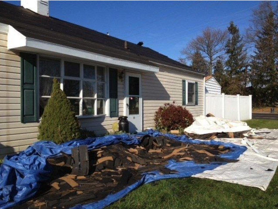 Photo of a messy job site after the roof tear off process